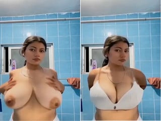 Indian chick flaunting huge breasts for a camera show.
