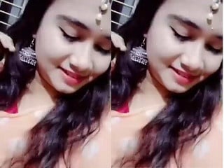 Indian girl strips and proudly displays sexy breasts for you.