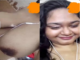 Indian chick flaunting huge breasts for a camera show.