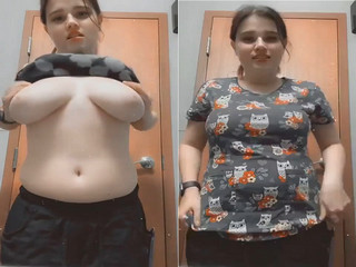 Indian chick flaunting huge breasts for a camera show.