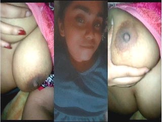 Indian chick flaunting huge breasts for a camera show.